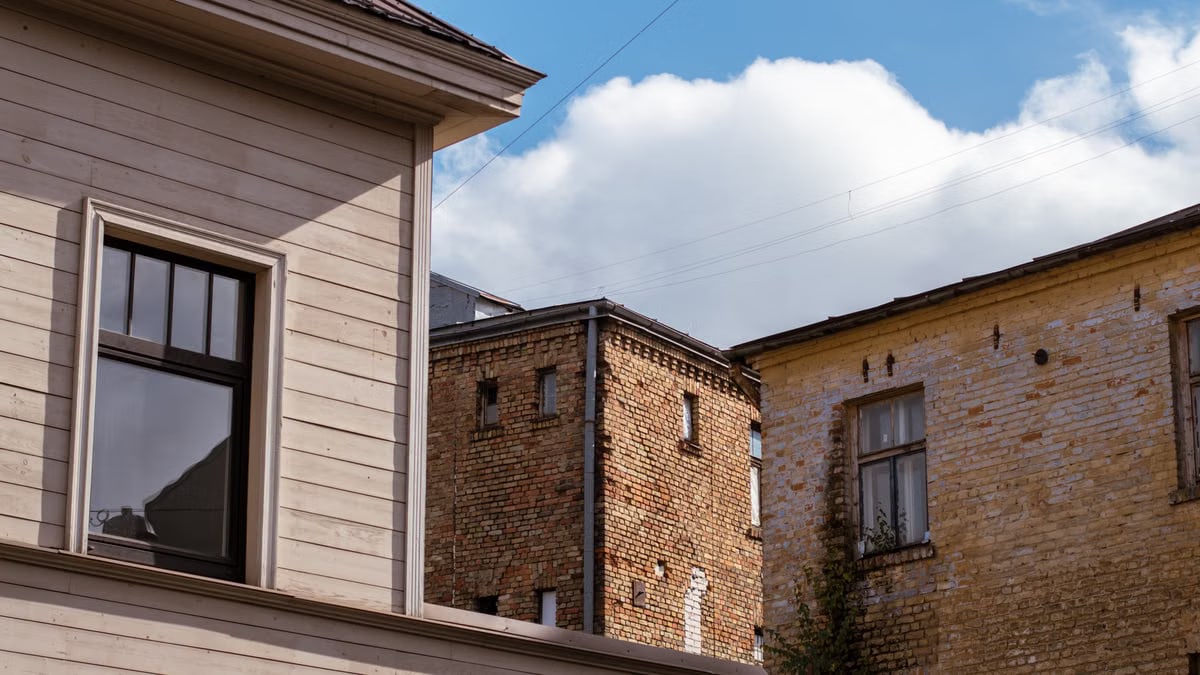 Quaint view of historic brick architecture in Riga, Latvia under a vivid blue sky.